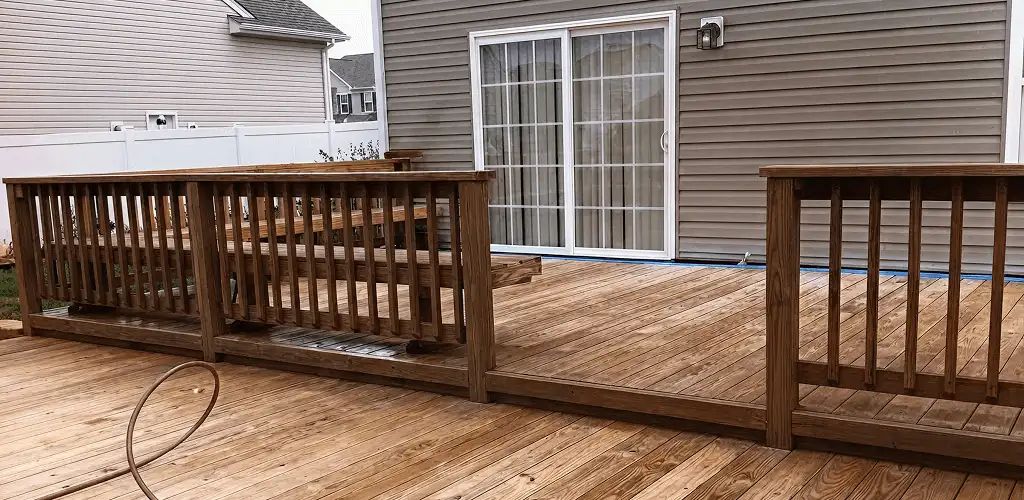 Deck sealing service protecting a backyard wood deck and railings in Detroit, MI