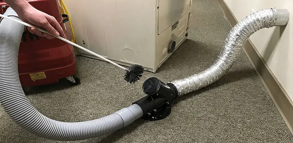 Dryer vent cleaning service removing lint from a dryer duct connection in Detroit, MI