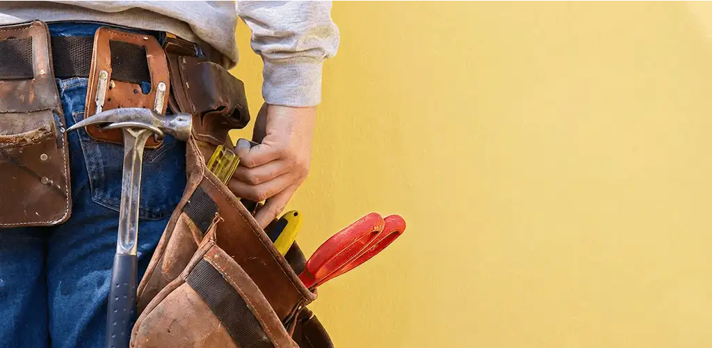 Handyman with tool belt ready for home repairs and maintenance in Detroit, MI