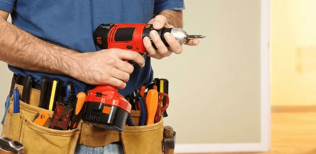 Handyman holding a power drill for home repairs and installations in Detroit, MI