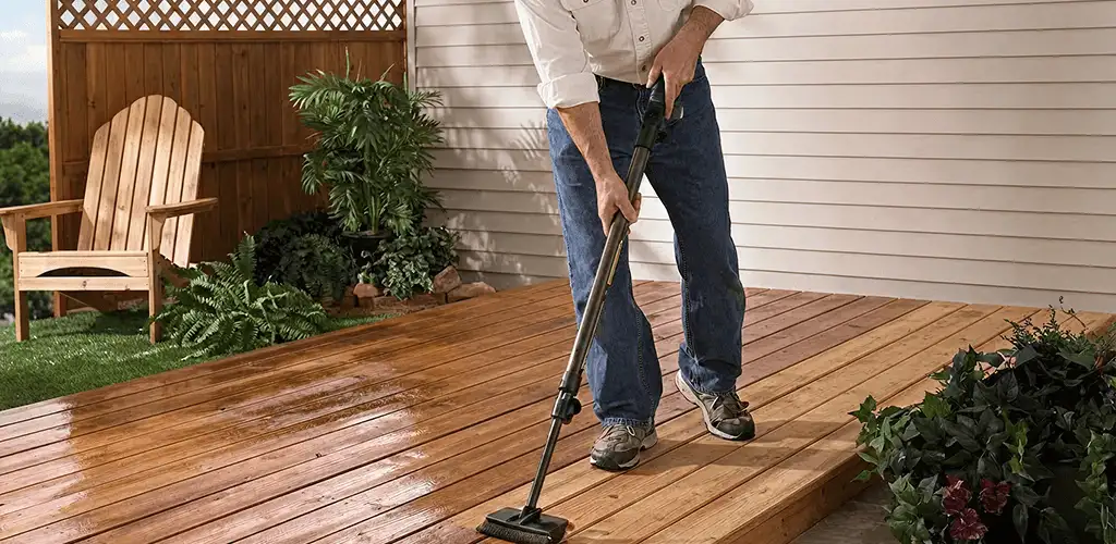 Deck staining service applying stain to a backyard wood deck in Detroit, MI